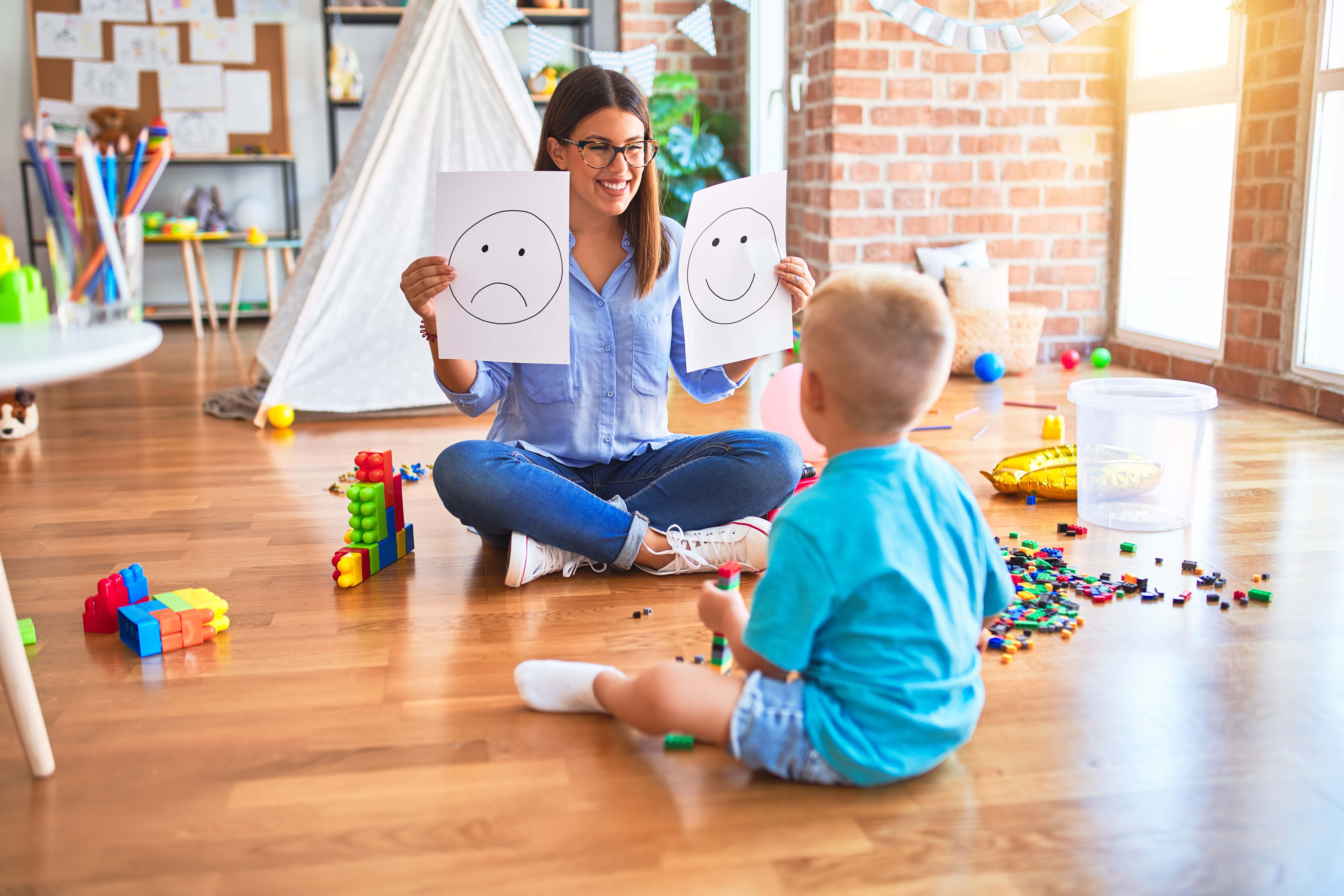 ABA therapist and child playing with blocks